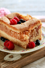 Apple pie decorated with raspberries and blueberries