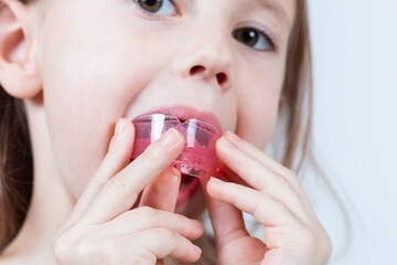 Adorable little girl puts myofunctional trainer in the mouth