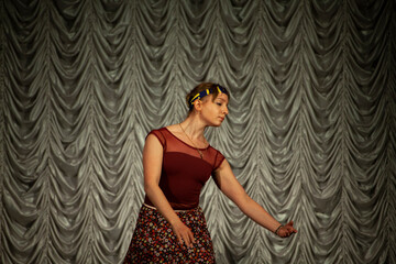 Girl dances on stage. Ballerina performs dance. Student shows skill. Choreography lesson.