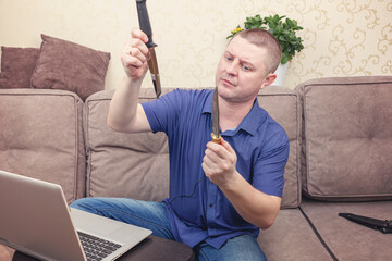 A man in a blue shirt blogs about knives and edged weapons