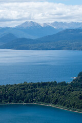 View of the Lake in the mountains in spring. Patagonian Coast Lake. Waves on the coast. Peninsula. Vertical Panoramic View. Vertical photo.	
