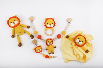 Crocheted lion figure toy for newborns, made with amigurumi art. It stands on a white background.