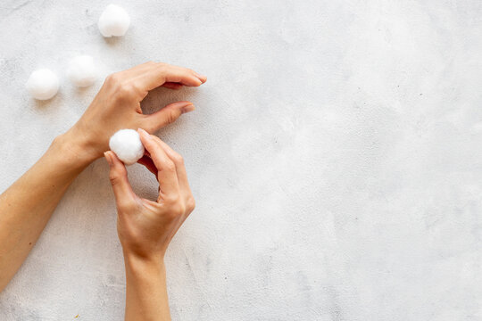 Female hands holding cotton wool balls for cleansing skin and boby care