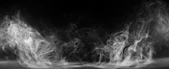 Panoramic view of the abstract fog. White cloudiness, mist or smog moves on black background....