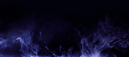 Abstract colored smoke moves on black background. Mystical swirling smoke rolling low across the ground.