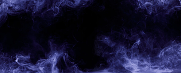 Abstract colored smoke moves on black background. Mystical swirling smoke rolling low across the ground.