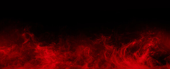 Abstract colored smoke moves on black background. Mystical swirling smoke rolling low across the ground.