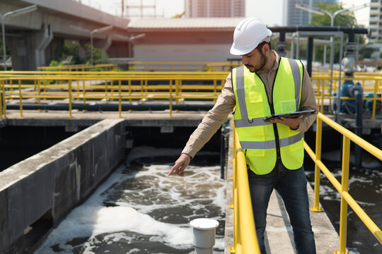 Wastewater treatment concept. Service engineer on  waste water Treatment plant. service engineer  checking on waste water treatment plant with pump on background. worker  working on Waste water plant.