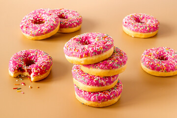 Close up of pink frosted donuts with colorful sprinkles