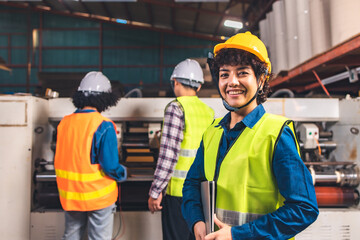 Engineer asian worker wearing safety helmet and vest holding clipboard and take note or tablet in...