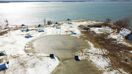 Top view snow covered campsites at northern shores Lake Grapevine, Texas  row of tent, pavilion,...
