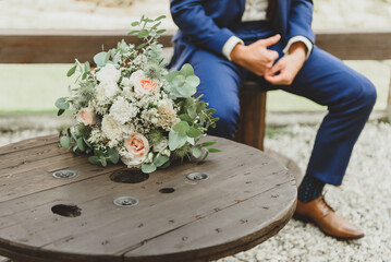 wedding. Groom with a bouquet waiting for the bride