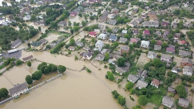 GALYCH, UKRAINE - JUNE 24, 2020: Flooded neighborhood street. Major flooding leaves city, underwater, entire community. Homes, houses overflowing water, insurance needed. helping people, Aerial View