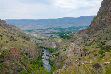 a small river runs between the mountains