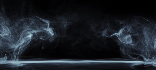Abstract smoke moves on black background. Swirling smoke.