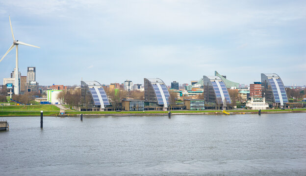 Capelle aan den IJssel, Netherlands - January 2022: Modern offices along river "Nieuwe Maas" near a suburb of the city of Rotterdam.