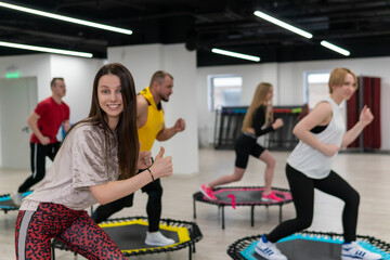 Women's and men's group on a sports trampoline, fitness training, healthy life - a concept...