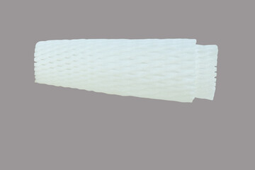 Foam plastic mesh net cushion white horizontal isolated on grey background. Blank covered yellow shockproof foam net for fruits protection. Protective packaging netting sleeves for fruit. Protect wrap