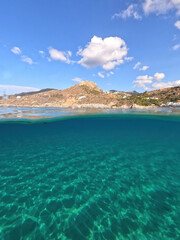 Fototapeta premium Underwater split photo taken from beautiful emerald bay and beach of Kapsali overlooking famous castle of Kythira island, Ionian, Greece