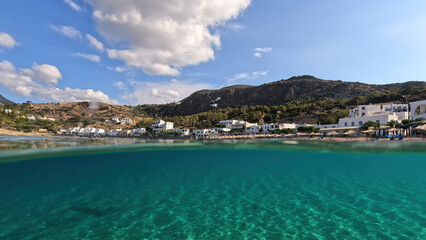 Underwater split photo taken from beautiful emerald bay and beach of Kapsali and famous Monastery of Saint John at the background, Kythira island, Ionian, Greece