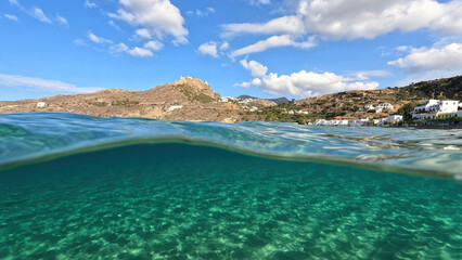 Underwater split photo taken from beautiful emerald bay and beach of Kapsali overlooking famous castle of Kythira island, Ionian, Greece