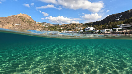 Fototapeta premium Underwater split photo taken from beautiful emerald bay and beach of Kapsali overlooking famous castle of Kythira island, Ionian, Greece