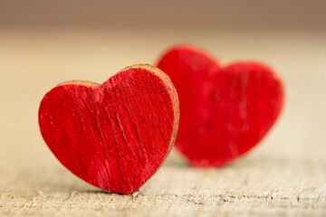 Valentine's Day greetings concept. Little red wooden hearts couple close up. Valentines greeting card.
