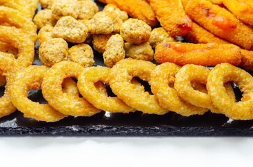 Southern fried and roast chicken bites, onion rings and mozzarella stick served on the stone plate