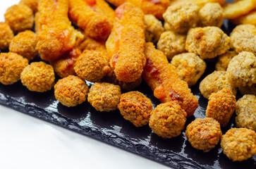 Southern fried and roast chicken bites, onion rings and mozzarella stick served on the stone plate