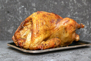 Homemade roast turkey, lemon close-up on a slate board on the table. Horizontal top view from above