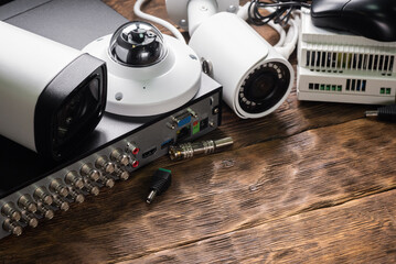 Modern white security cameras on the table background. Video surveillance equipment concept...