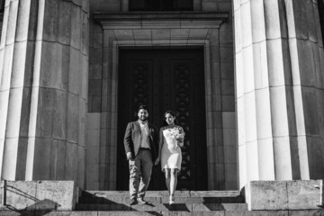 modern latin newlywed couple walking down stairs, black and white photo