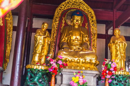Buddhist golden statue in Yinjiang Temple, Anqing, China. .