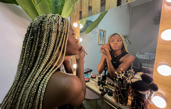 Afro Young Woman Putting On Makeup