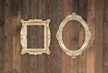 artistic gold frame on wooden wall