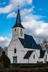 Fototapeta na wymiar Oppem, Flemish Brabant Region, Belgium - 02 05 2022: The white catholic church of the village