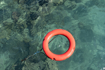red lifebuoy floats in the sea