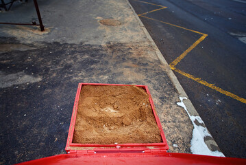 Grit bin with sand material, improve traction on snowy and icy sidewalk at bus stop, road...