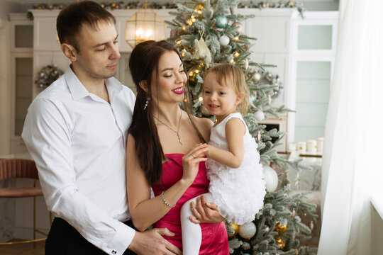 A family poses in a photo studio with a New Year's interior.