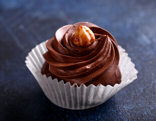 Meringue, pavlova chocolate cupcakes with cream and nuts