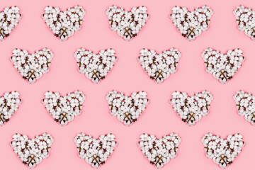 Seamless pattern of hearts made of cotton flowers