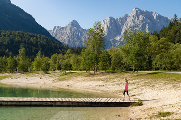 Fototapeta na wymiar Children by the lake near village Kranjska Gora in Triglav national park, Slovenia