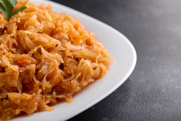 Traditional Homemade Stewed cabbage on white plate.