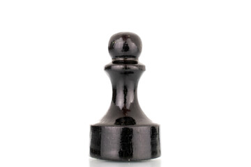 One old wooden chess piece in black, macro, isolated on a white background.