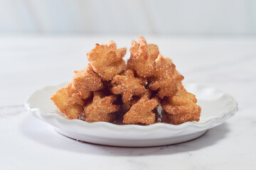 Mexican churros served on a homemade plate.