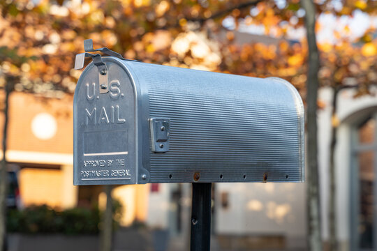 DRESDEN, GERMANY - 28. October 2021: US Mailbox Standing On A Yard. Metal Box For Receiving Letters And Small Packages. Typical American Lifestyle Decoration Object At Home.