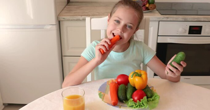 little girl in the kitchen. the child loves vegetables. healthy food concept. vitamins for a child