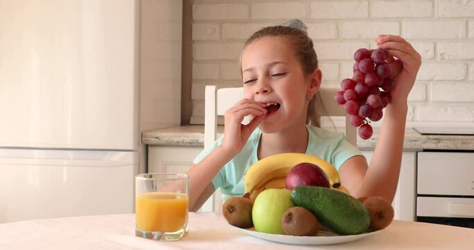 the child eats fruits with pleasure. The girl eats healthy food. the concept of children's health