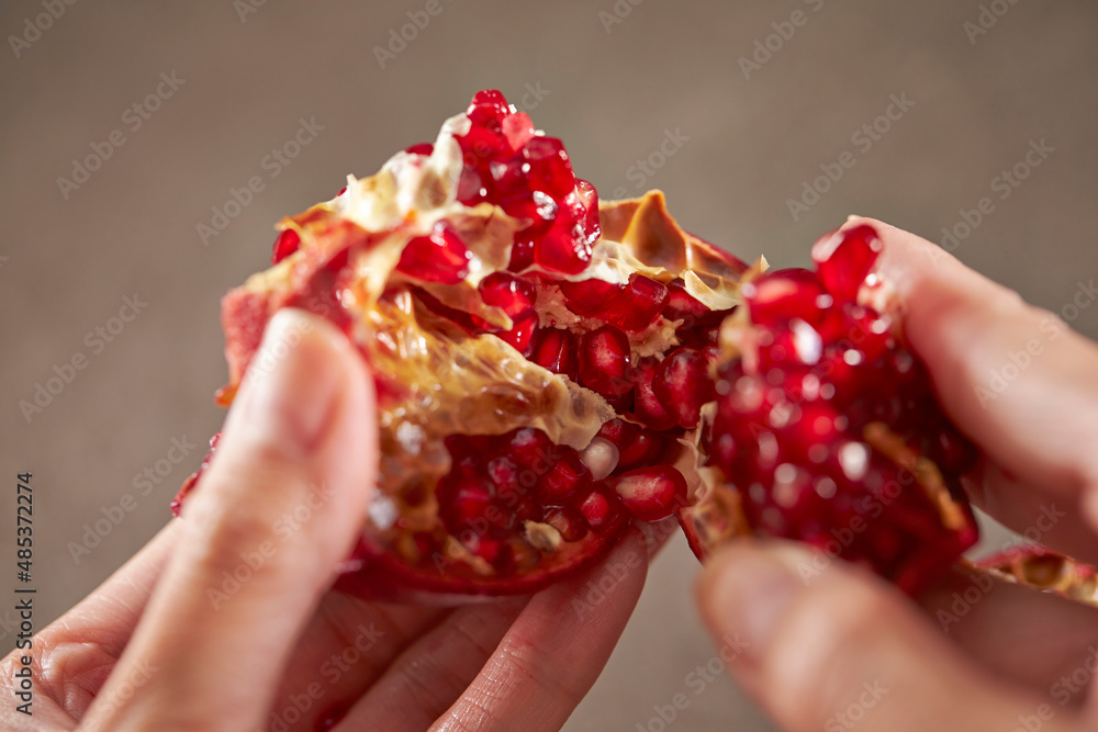 Sticker Ripe pomegranate grains in hand