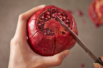Ripe pomegranate cut with a knife